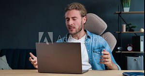 Stressed overworked Businessman feels frustrated by data loss, using Laptop at Home Office. Shocked male user looks at Computer screen reads bad news, has Unexpected online Website problem.