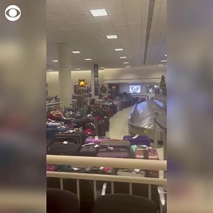 LUGGAGE PILE-UP: Heaps of unclaimed luggage were seen in Chicago's international airport just after midnight on Tuesday amid massive flight cancellations caused by the powerful and deadly winter storm. https://cbsn.ws/3GkJzcV | CBS News