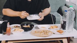 Download A man eating food on a table with other food for free