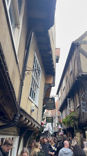 35K views · 634 reactions | ✨ Wandering down the Shambles feels like stepping straight into medieval York, narrow timber buildings leaning so close they almost touch, with old metal hooks still hanging where butchers once displayed their meat. A street that holds centuries of stories in every beam and brick. ️️✨ #York #TheShambles #HistoricYork #MedievalYork #HiddenYork #YorkshireCharm #VisitYork #YorkStreets #YorkshireHistory #OldYork | Visit Yorkshire Tours | Facebook