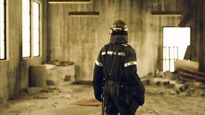 CGI Worker in safety gear surveying a construction site during daylight hours