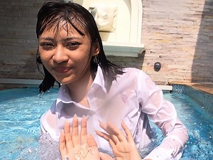 Playing in the pool in her business suit