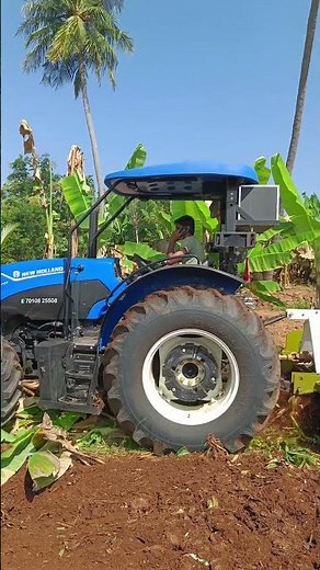 New Holland workmaster on field