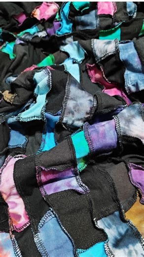 I am rearranging the studio and I came across a large pile of t shirt remnants which were perfect for creating a patchwork tunic with a cowl collar in jewel shades with a black contrast. I have MANY t shirt strips so I decided to make a shirt, with elbow length sleeves as well. It is somewhat heavy to wear as a t shirt in summer but it will be perfect as a layering piece over a solid colored longer sleeved t shirt or even a shirt with a collar in autumn and winter and even on cool spring days. I