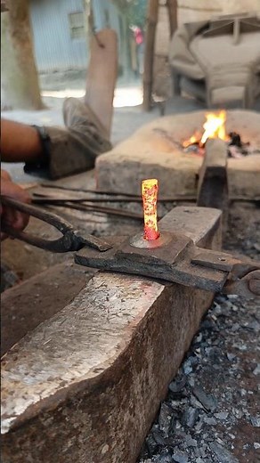 Watch how a skilled blacksmith hand-forges nails from old iron by hammering it into shape."