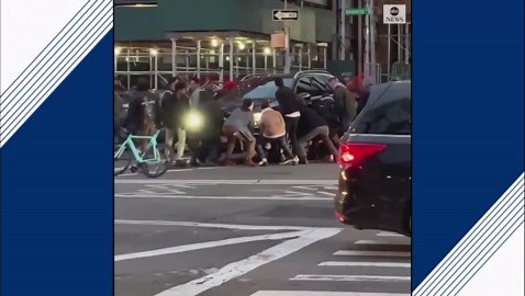 Passers-by lift SUV off woman in traffic incident