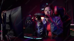 Frustrated girl gamer loses the game, removes the headset and leaves the playing area