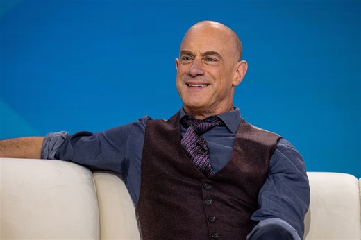 Only Chris Meloni Can Pull Off Black Leather Pants & a Knee-Length Rainbow Scarf