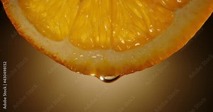 Water dropping from yellow pulp of fresh citrus fruit. Close up orange slice rich in vitamin c used for detoxification drinks 4k footage