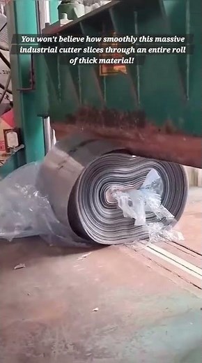 The Power of Hydraulics: Industrial Guillotine Shearing a Massive Material Roll