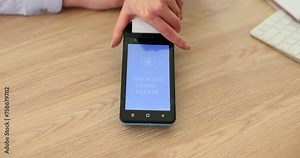 Woman banker gives client bank portable terminal to pay