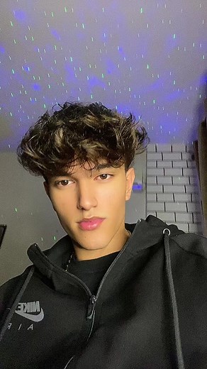 Person in Nike Hoodie with Starry Ceiling Projection