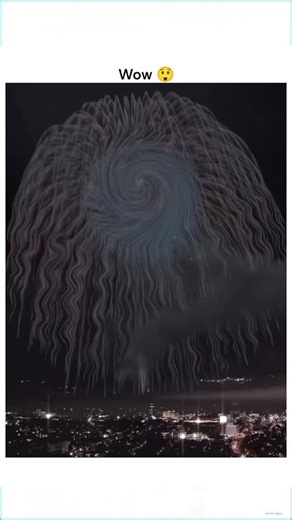 The Trends Shots on Instagram: "The post shares a 7-second video of fireworks forming a surreal, swirling dome over a city skyline at night, with vibrant red, blue, and purple bursts creating a hypnotic spiral that feels like a portal opening in the sky. �Authored by @YourHandle, this silent visual captures the magic of a “blink-and-you-miss-it” moment, inviting viewers to pause their scroll and lose themselves in pure visual storytelling for just a few seconds. �Viewer reactions, including comm