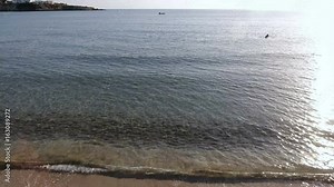 Beautiful woman comes out from waters of ocean