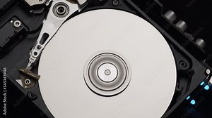 Macro, Close-Up of Computer Hard Disk Drive Spinning and Writing. Blue Lights Blinking. 4k