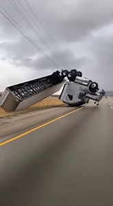 Severe Winds Flip Semi-Truck on Highway Casper, Wyoming — April 12, 2025 Terrifying footage captured the moment a semi-truck was tossed like a toy by powerful crosswinds on a desolate stretch of highway yesterday afternoon. As dark storm clouds gathered overhead, the sheer force of the wind caught the side of the trailer, lifting the wheels off the pavement before the entire rig succumbed to gravity and flipped onto its side. The video shows a dark SUV traveling in the lane adjacent to the tract