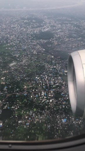 Aerial View of a Vibrant Cityscape from Airplane Window