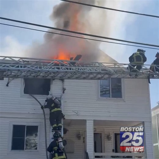 BREAKING: Flames could be seen shooting from a second-floor window as crews battled a raging blaze at a multi-family home in Boston on Tuesday morning. | Boston 25 News