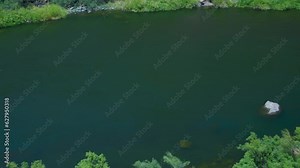 Salt River flows into the Roosevelt Dam in Arizona. it is surrounded by the desert landscape, cactus, and wild animals.
