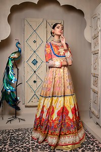Miranjani 92 3120000285 https://www.zahraahmad.com/luxury-pret A gorgeous zari organza gown with gold zari pattern panels,daaman flare with digitally printed silk in orange and yellow hues finished with gold sequins embroidery. Neckline bodice on orange shimmer base with gold lotus embroidery | Zahra Ahmad