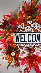 Welcome the beauty of nature into your home with this vibrant Monarch Butterfly Welcome Wreath! Featuring stunning orange monarch butterfly accents, this wreath bursts with cheerful florals, lush greenery, and bright hues of orange, pink, and white. The focal point is the charming “Welcome” sign adorned with detailed monarch butterfly designs, creating a warm and inviting greeting for your guests. Handcrafted with high-quality materials, this wreath is filled with layers of premium ribbons, incl