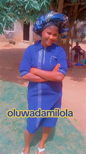 Oluwadamilola in a Stylish Blue Dress Outdoors