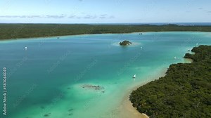 Traditional pirogue boats with sails transport tourists in Upi Bay, Isle of Pines - aerial
