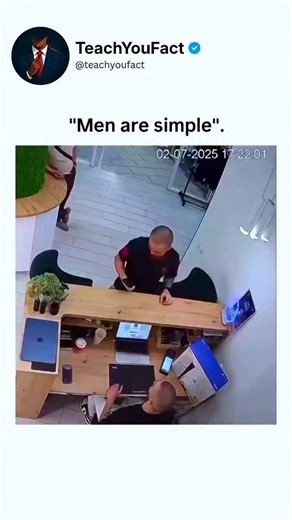 teachyoufact on Instagram: "This security camera clip captures a pure, unfiltered moment of joy inside a modern electronics store, likely an Apple-style or premium tech retail space. Filmed from an overhead CCTV angle with an Imou watermark and timestamped July 2, 2025 at 17:22, the video shows a bald man in a black t-shirt and white pants approaching a wooden display counter filled with laptops, phones, and accessories, surrounded by sleek fixtures and indoor plants. The instant he notices a bl