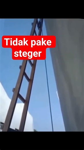 plastering the walls with a hanging ladder and rope