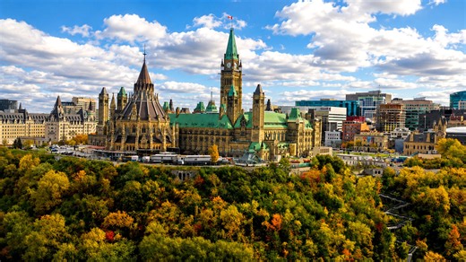 Ottawa’s Parliament Hill rising above autumn trees