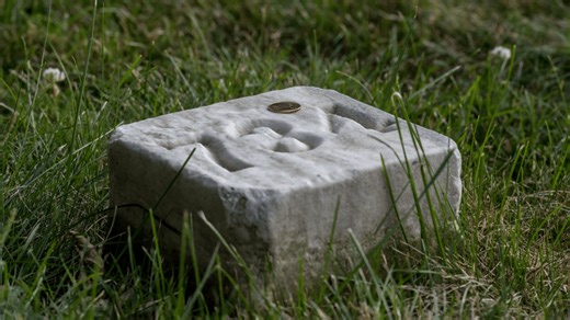 Coins on a soldier’s headstone: What do they mean?