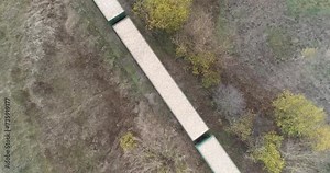 Woodworking, view from height on a freight train loaded with sawdust, transportation and loading the tree.