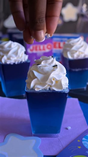 JELL-O on Instagram: "Blast off! 🚀 These Galaxy JELL-O Cups are layered with vibrant JELL-O flavors, then topped with a cloud of Cool Whip and cosmic sprinkles 💫 Ingredients: 1 Package (3 oz) Berry Blue JELL-O 1 Package (3 oz) Grape JELL-O 2 Cups Boiling Water (1 cup per flavor) 2 Cups Cold Water (2 cup per flavor) Cool Whip Sprinkles How to Make It: 1. Add 1 cup boiling water to Berry Blue JELL-O mix, stir for 2 mins until completely dissolved. Then stir in 1 cup cold water. Repeat with Grape