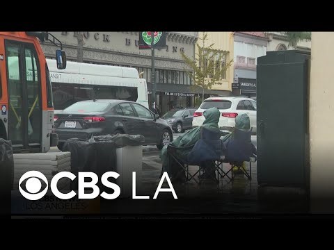 Rose Parade spectators begin lining streets of Pasadena despite rain and cold temps