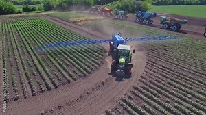 Spraying machine watering agricultural field. Agricultural sprayer fertilizing on farming field. Agriculture watering. Farming machinery for pesticide sprayer. Fertilizer spreader