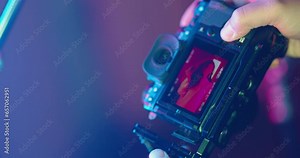 Backstage professional fashion photo shoot on camera screen. Photographer's work behind the scenes. Multi-colored professional photo shoot with a model girl. Modern people, young adult and youth