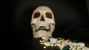 clip-1108973537-pile-medicine-tablets-drug-pills-poured-into