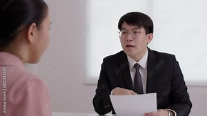 CEO man or HR boss in suit search new hire vacancy labor ask in CV career paper at office desk. Asia SME owner or lawyer people listen or coach talk to worker agent, teach intern, advice bank loan.