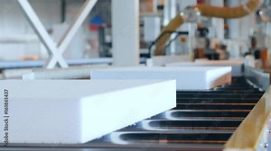 production equipment at industry, production of foam plastic, processing of styrofoam in factory, automated complexes manufacturing polyvinyl chloride foams, styrofoam on conveyor line,