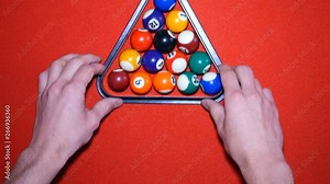 Billiards. Put the pyramid in billiards. Beginning of game of billiards, put a pyramid with balls. Billiard balls on the billiard table. Red table and multi-colored balls. Stock Video