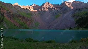 Sunset hiking trail wildflowers Lower Blue Lakes wildflowers Mount Sneffels Wilderness summer Ridgway Telluride Colorado Rocky Mountains Uncompahgre National Forest San Juan Dallas Range forward pan Stock Video