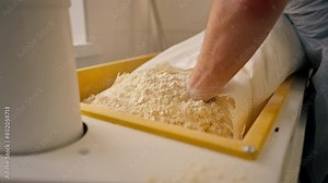 Close-up of a baker sifting flour from a cut bag of flour on a flour sifting machine in professional kitchen Stock Video