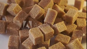 cane lump sugar. rotating brown sugar cubes. Demerara golden brown sugar. close up