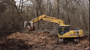 Bucket of backhoe digging soil at construction site. Crawler excavator digging. Excavating machine. Earth moving equipment. Excavation vehicle. Erection business.