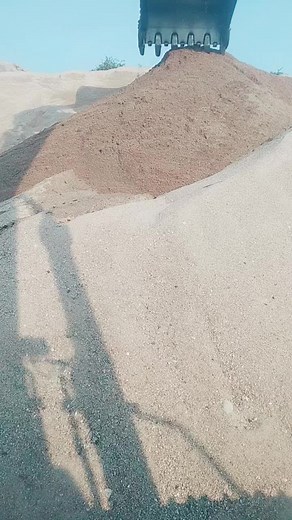 Excavator Sand Dumping in Scenic Landscape