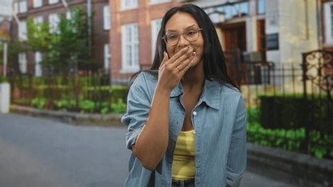clip-3983553141-young-brunette-woman-yawning-hand-covering-mouth