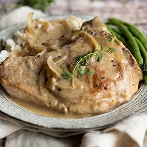 2.4K views · 15 reactions | Smothered pork chops are pure comfort food! Thick bone-in pork chops are pan seared, and then smothered in a delicious creamy onion and mushroom sauce. RECIPE: https://www.rachelcooks.com/smothered-pork-chops/ | Rachel Cooks | Facebook