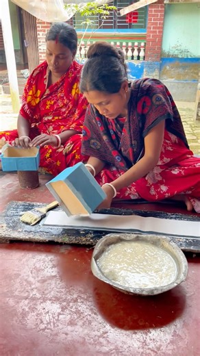 See how two brides make packets of sweets together.