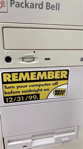Anthony Polanco on Instagram: "It’s a Y2K joke. The sticker says: “REMEMBER: Turn your computer off before midnight on 12/31/99,” with a Best Buy logo, slapped onto an old Packard Bell PC. This references the late-1990s panic over the Year 2000 (Y2K) bug, when people feared computers would crash, corrupt data, or cause infrastructure failures because many systems stored years as two digits (“99” → “00”). The humor comes from hindsight. Nothing apocalyptic happened, yet the warning looks absurdly