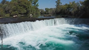 Amazing view of Manavgat waterfall in Turkey. Manavgat waterfall Manavgat River is near the city of Side, 3 km north of Manavgat. A wide stream of water falls from a low height. Drone shooting